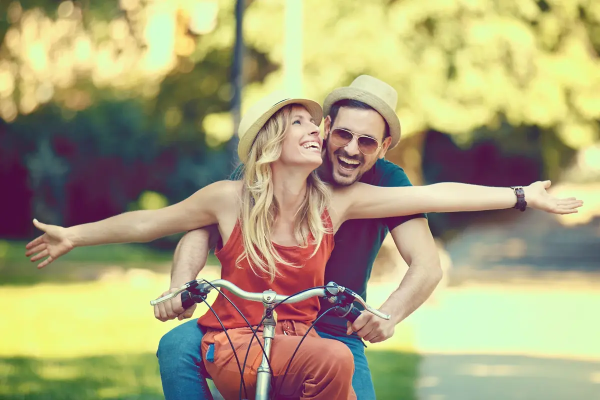 Happy Couple Riding a Bike