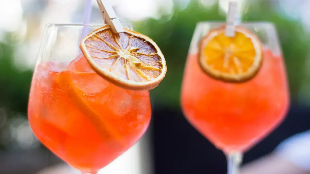 Aperol Spritz z lodem i pomarańczą w wysokich kieliszkach 