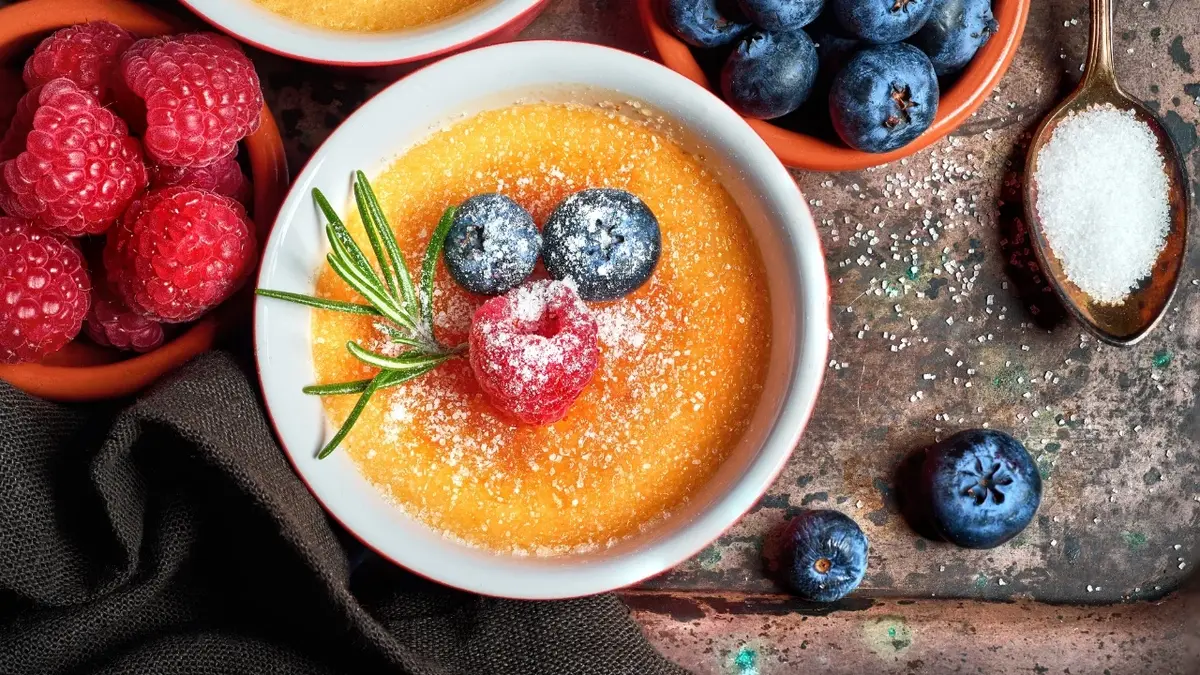 Creme brulee w kamionkowym naczyniu z owocami